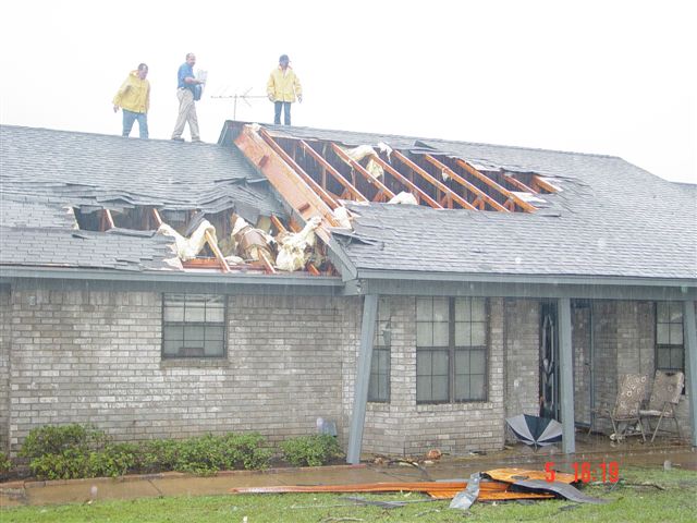 House still stands, with large portions of the roof missing.
